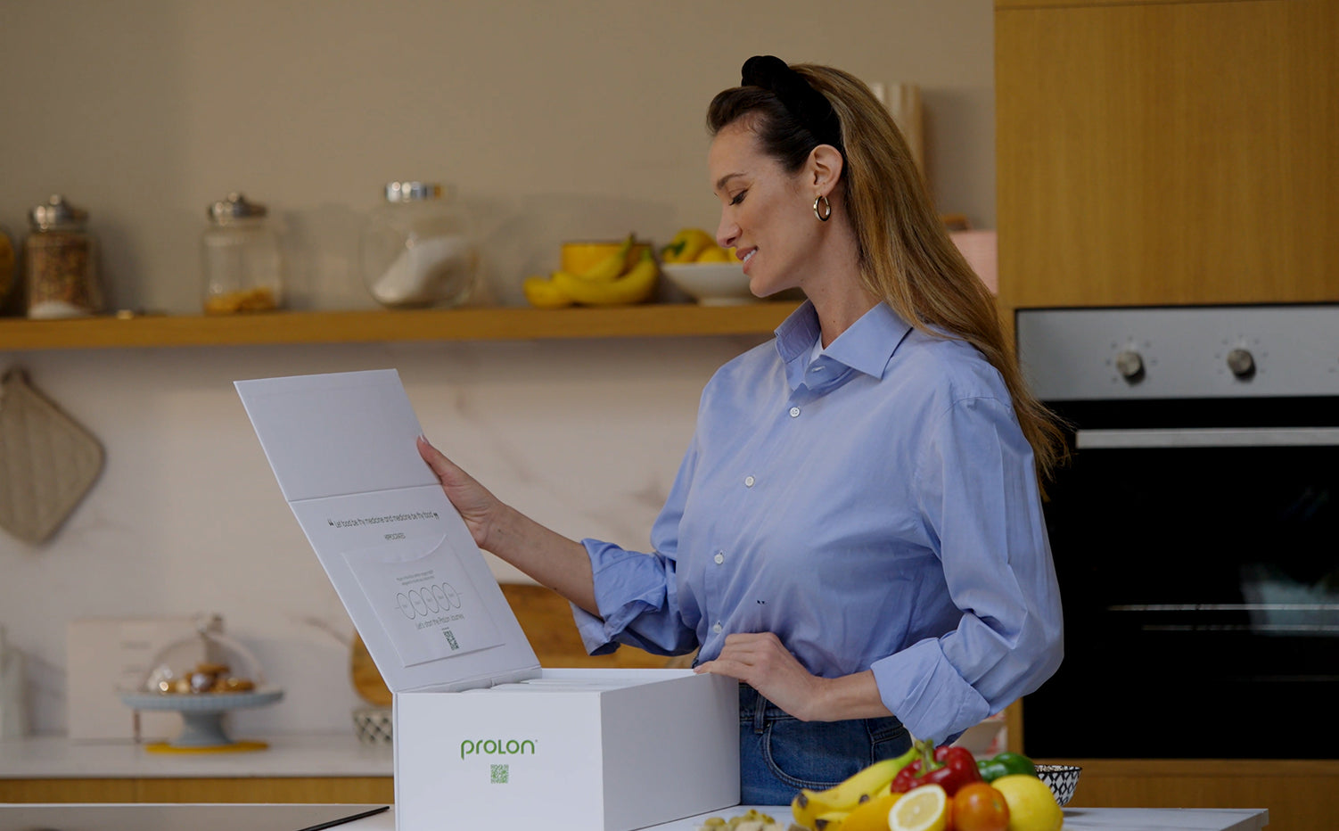 Woman unpacking a ProLon box on a kitchen counter
